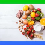 an assortment of fruits and nuts on white wooden planks