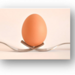 An egg balancing on 2 forks