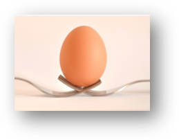 An egg balancing on 2 forks