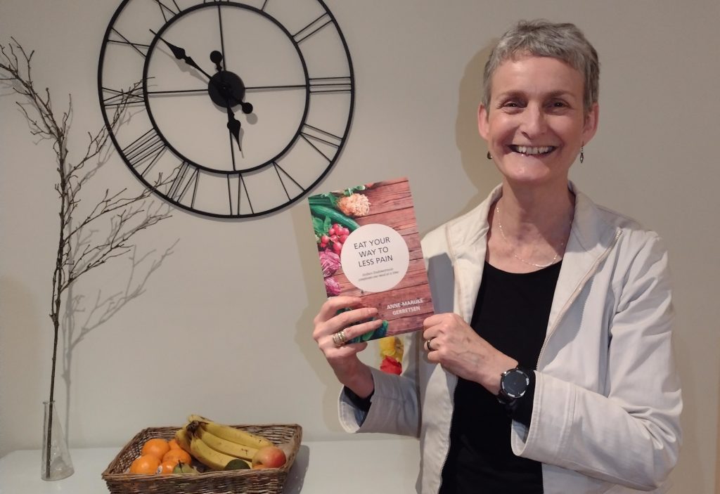 Anne-Marijke holding up a copy of her book